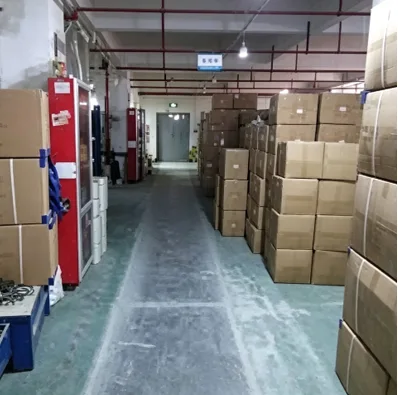 Standardized high-bay industrial warehouse corridor with high-density vertical racks storing neatly palletized master cartons of automotive wholesale supplies